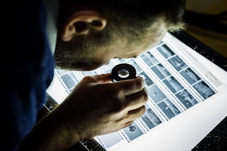 Person inspecting negatives